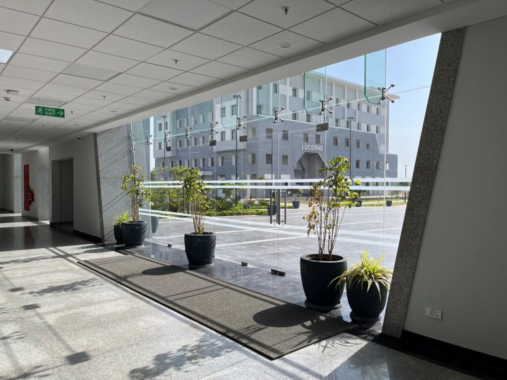 Modern institutional building corridor with glass façade, maintained operational environment, and integrated facility infrastructure.
